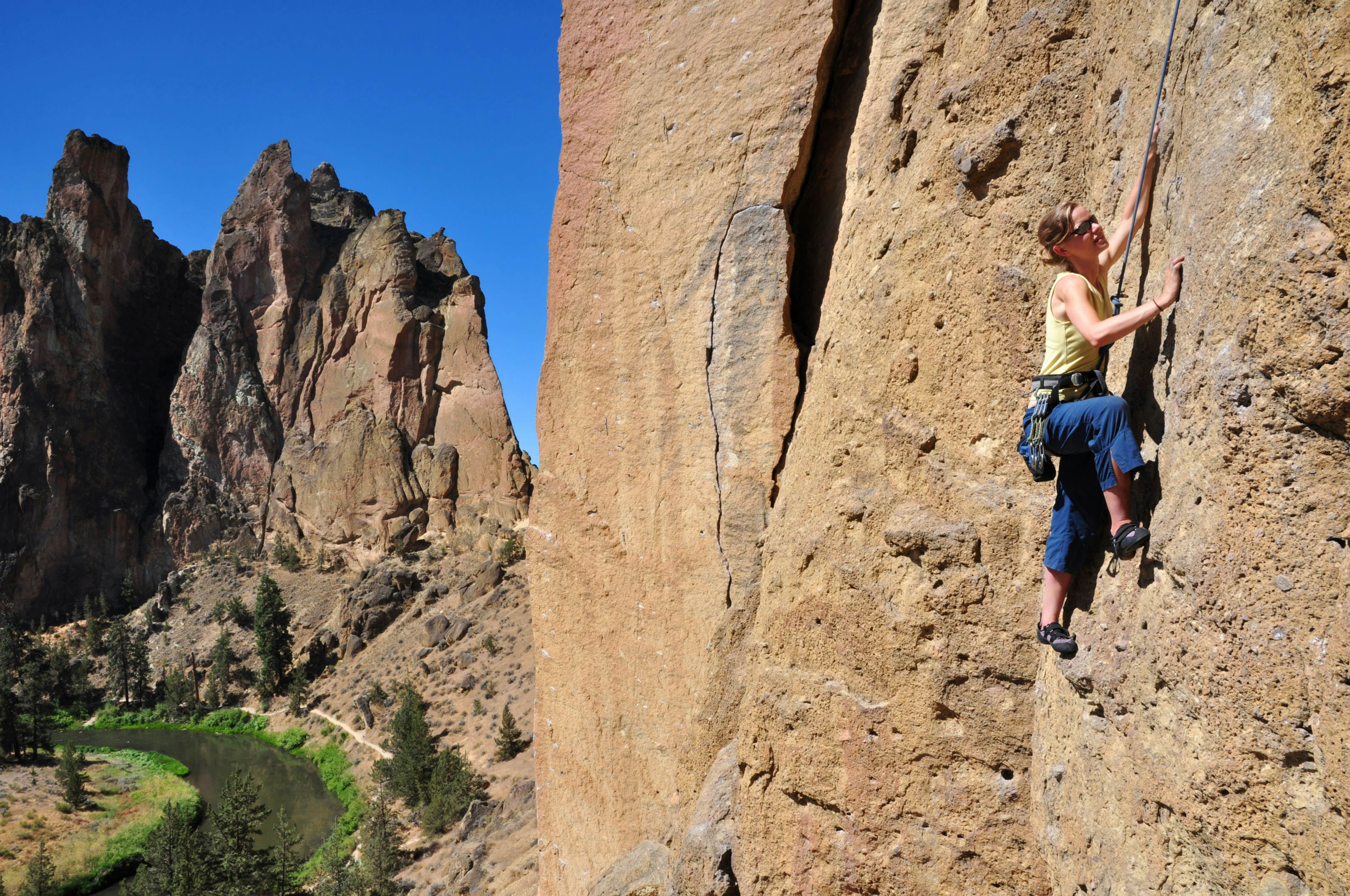 Smith Rock State Park landscape with a woman rock climber, Oregon, USA