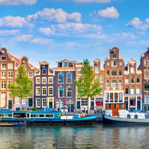 Row of colorful townhomes in Amsterdam, Netherlands along a historic canal