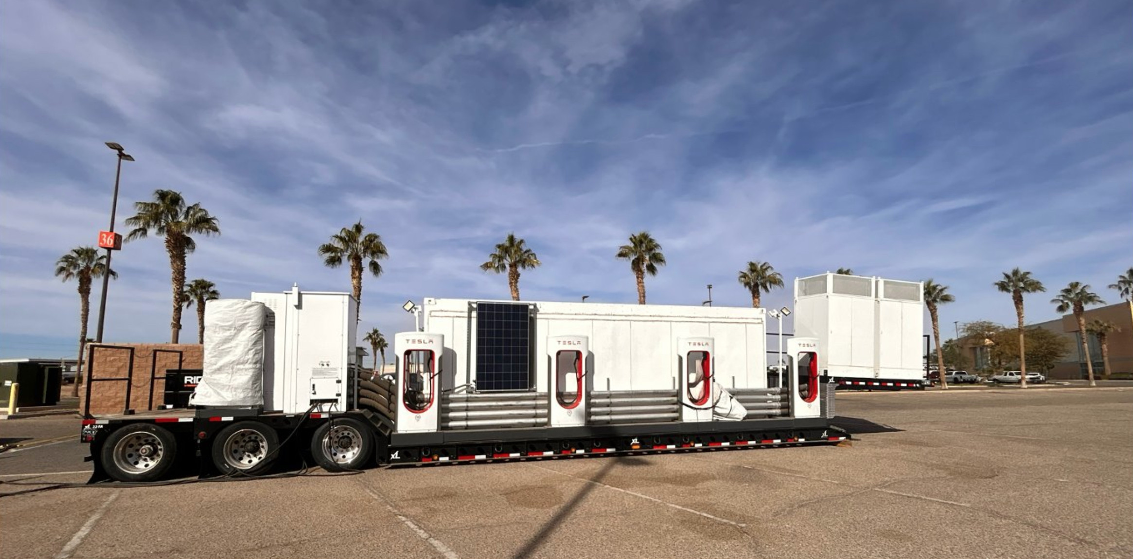 Trạm sạc Tesla Megapack di động tại một địa điểm Supercharger hiện có, cung cấp giải pháp sạc nhanh chóng và hiệu quả cho xe điện trong mùa lễ hội cao điểm.