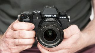 Fujifilm X-S20 camera in hand